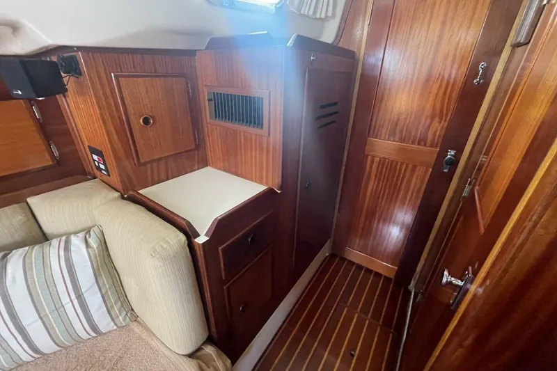 Slide: The Image of Interior of 1981 Pearson 36 sailboat with wooden cabinetry and striped cushions. - 21