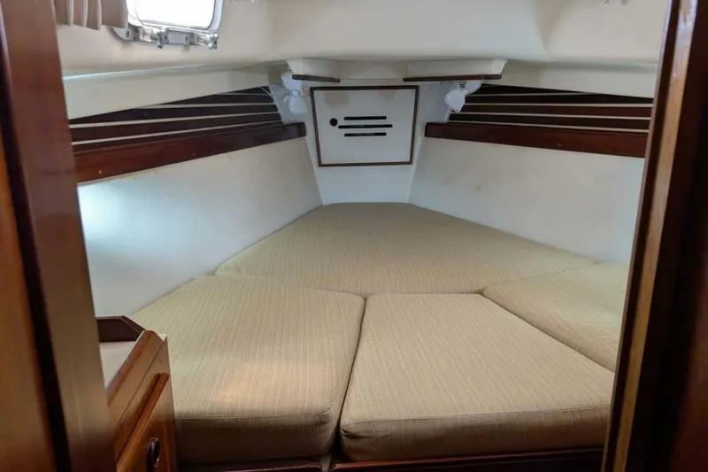 Slide: The Image of Cozy cabin interior of 1981 Pearson 36 sailboat with beige cushions and wooden accents. - 22
