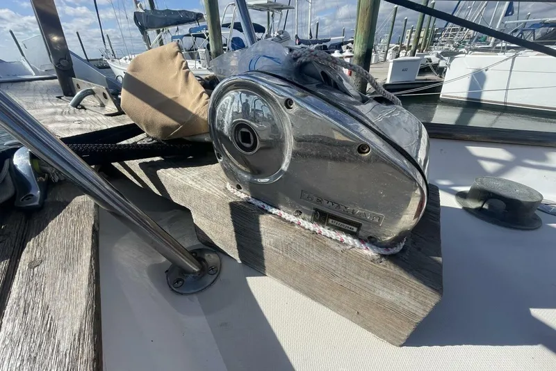 Slide: The Image of 1981 Pearson 36 sailboat deck with winch and ropes in marina setting. - 27