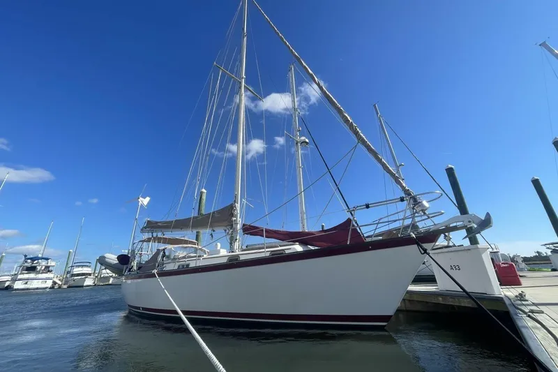 Slide: The Image of 1981 Pearson 36 sailboat docked at marina under clear blue sky. - 28