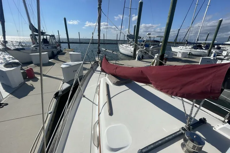 Slide: The Image of 1981 Pearson 36 sailboat docked at marina under clear blue sky. - 3