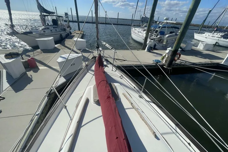 Slide: The Image of 1981 Pearson 36 sailboat docked at marina, sunny day, calm waters. - 4