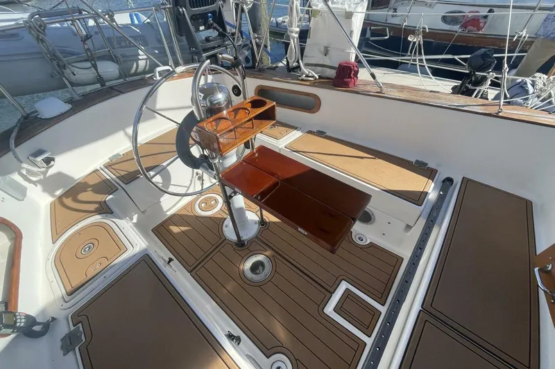 Slide: The Image of Cockpit of a 1981 Pearson 36 sailboat with wooden accents and steering wheel. - 7