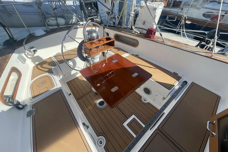 Slide: The Image of Cockpit of 1981 Pearson 36 sailboat with wooden table and steering wheel. - 8