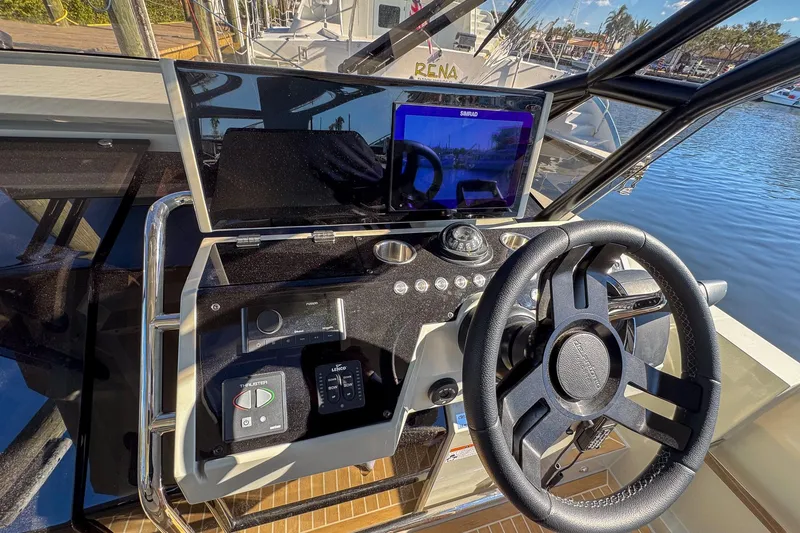 Slide: The Image of Helm of 2026 De Antonio Yachts D32 with modern navigation controls and steering wheel. - 23
