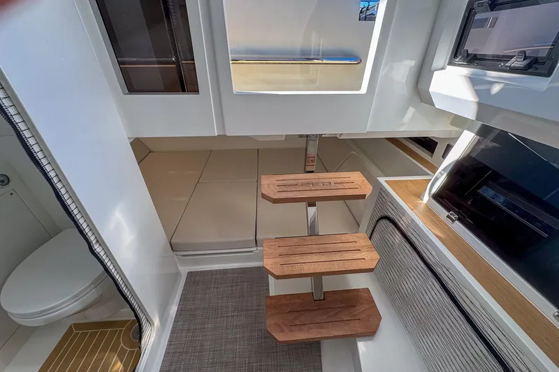 Slide: The Image of Interior of 2026 De Antonio Yachts D32, featuring modern wooden steps and sleek design. - 32