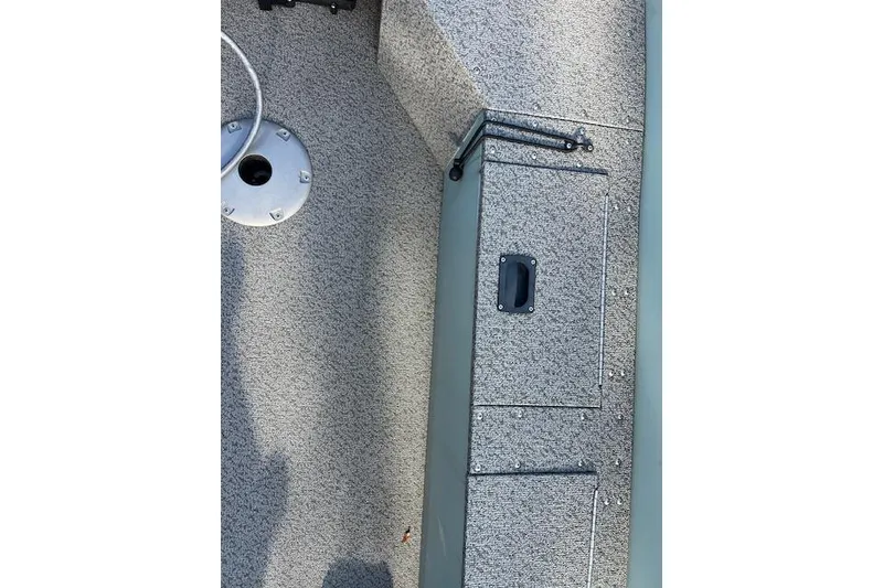 Slide: The Image of 2024 Starcraft Patriot 16 SC boat interior with storage compartment and textured flooring. - 5