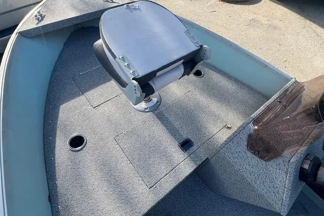 Slide: The Image of 2024 Starcraft Patriot 16 SC boat interior with seating and storage compartments. - 7