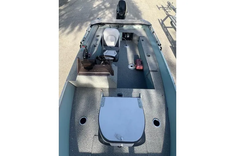 Slide: The Image of 2024 Starcraft Patriot 16 SC boat interior with steering console and seating. - 8