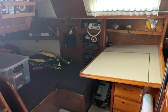 Slide: The Image of Interior of 1983 Ericson 381 sailboat with navigation station and storage. - 10