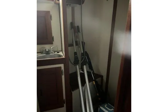 Slide: The Image of 1983 Ericson 381 sailboat interior with sink and stored equipment. - 16