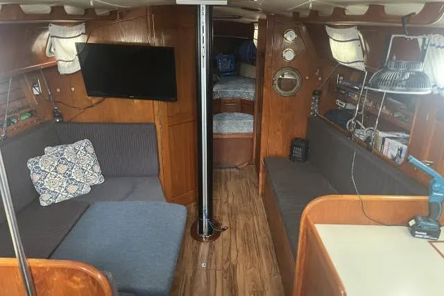 Slide: The Image of Interior of 1983 Ericson 381 sailboat with cozy seating, wood finish, and nautical decor. - 2