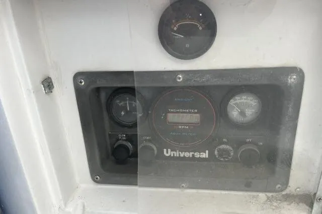 Slide: The Image of Control panel of a 1983 Ericson 381 sailboat with Universal tachometer. - 23