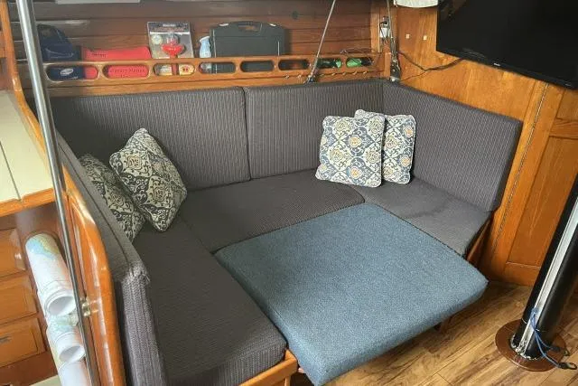 Slide: The Image of Cozy interior of 1983 Ericson 381 sailboat with cushioned seating and decorative pillows. - 3