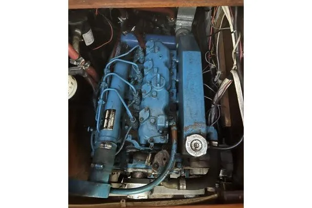 Slide: The Image of Blue engine inside 1983 Ericson 381 sailboat, showcasing mechanical components and wiring. - 34