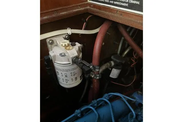 Slide: The Image of Engine compartment of 1983 Ericson 381 sailboat, showing fuel filter and hoses. - 35