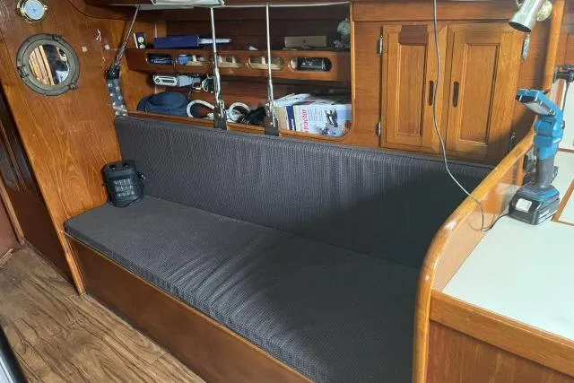 Slide: The Image of Interior of 1983 Ericson 381 sailboat with wooden cabinetry and cushioned seating. - 4