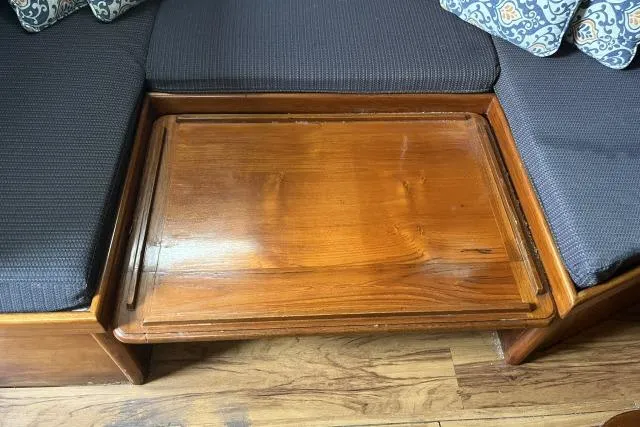 Slide: The Image of Wooden table on Ericson 381 sailboat, 1983 model, surrounded by blue cushioned seating. - 5