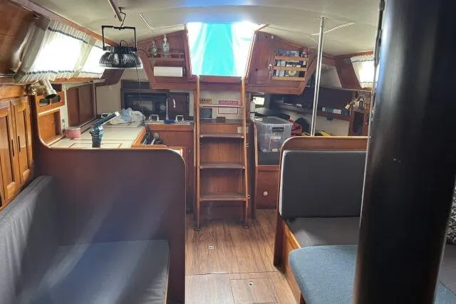 Slide: The Image of Interior of 1983 Ericson 381 sailboat with wooden furnishings and seating area. - 6