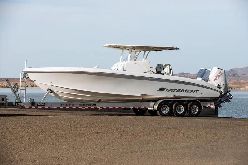 The Image of 2026 Statement 350 Open boat on trailer by the water, featuring sleek design and powerful engines. - 0