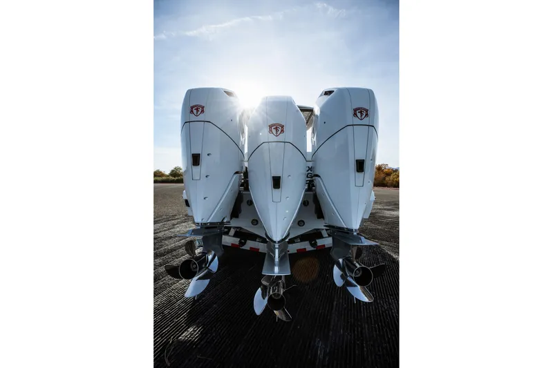 Slide: The Image of Triple outboard engines on a 2026 Statement 350 Open boat, sunlit background. - 12