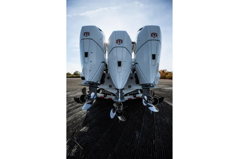 Slide: The Image of Triple outboard engines on a 2026 Statement 350 Open boat, viewed from the rear. - 13