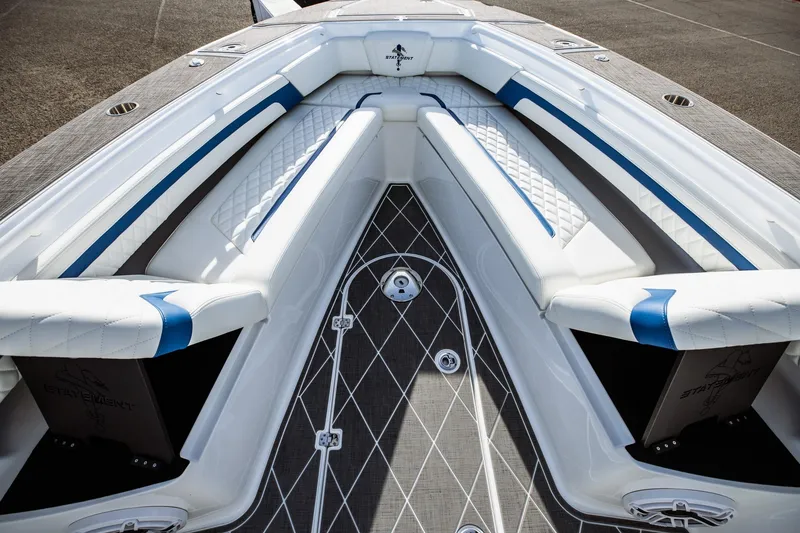 Slide: The Image of 2026 Statement 350 Open boat interior with white and blue cushioned seating. - 26