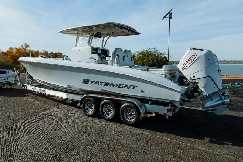 Slide: The Image of 2026 Statement 350 Open boat on trailer, featuring powerful 400 engine, parked near water. - 3