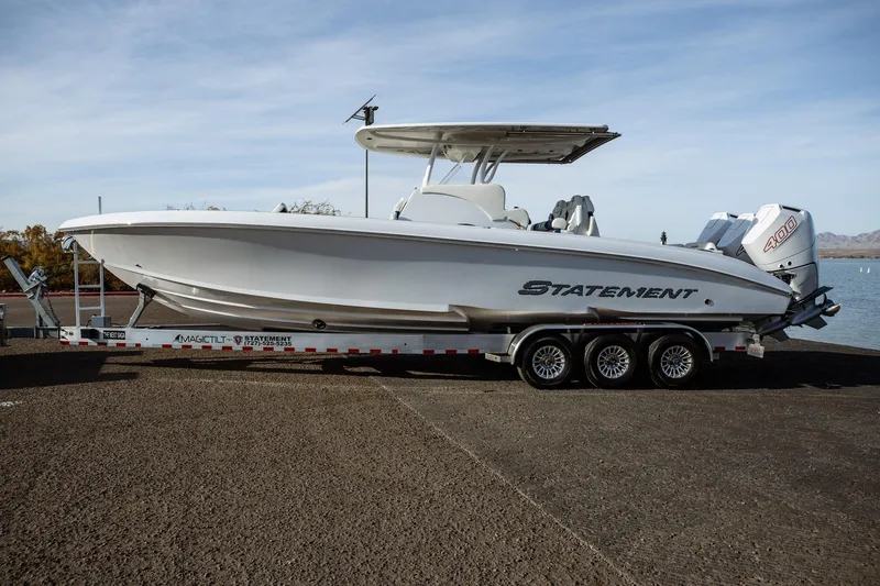 Slide: The Image of 2026 Statement 350 Open boat on trailer by the water, featuring sleek design and powerful engines. - 6