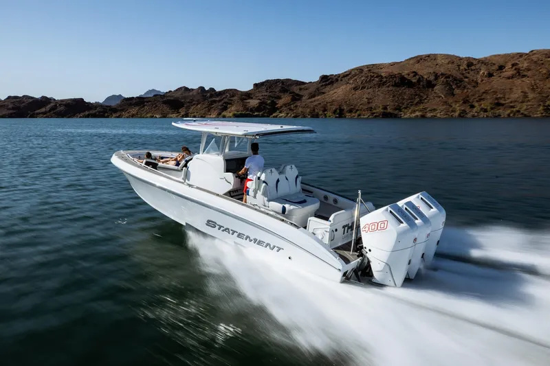 Slide: The Image of 2026 Statement 350 Open boat cruising on a lake with passengers, featuring powerful engines. - 7