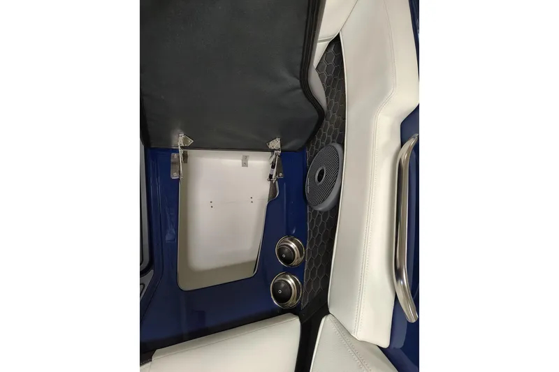 Slide: The Image of 2026 Cobalt R6 Surf interior detail with speaker, white seating, and metallic handle. - 11