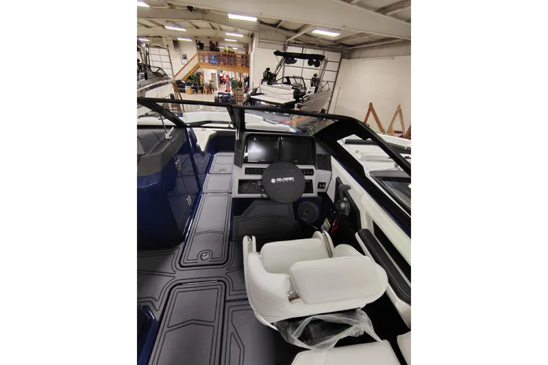 Slide: The Image of 2026 Cobalt R6 Surf boat interior with modern dashboard and white seating. - 14
