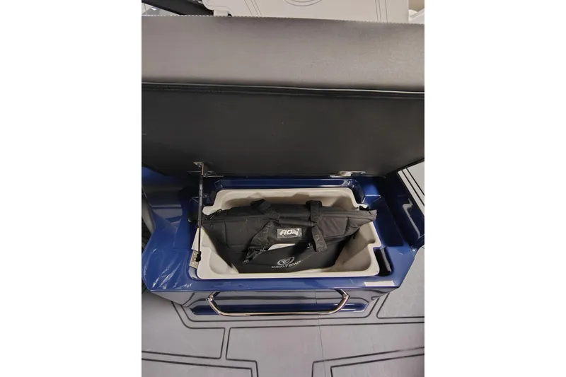 Slide: The Image of 2026 Cobalt R6 Surf boat storage compartment with a black bag inside. - 15