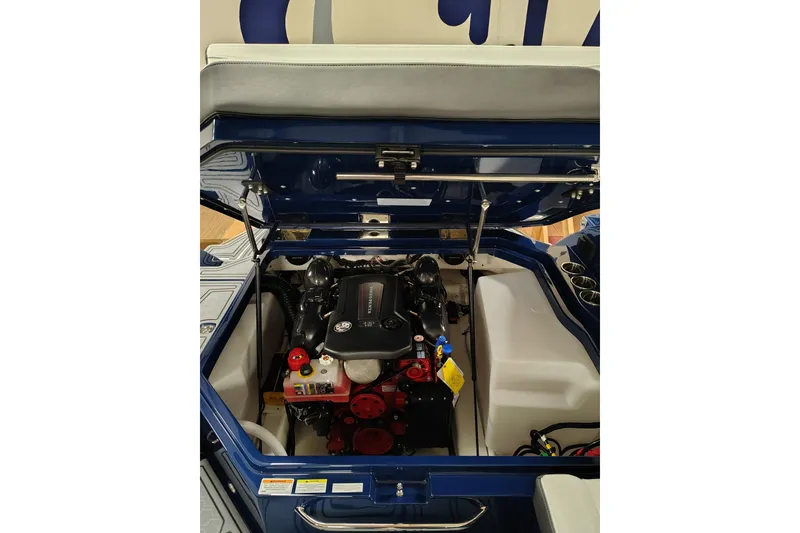Slide: The Image of 2026 Cobalt R6 Surf boat engine compartment with open hatch, showcasing engine details. - 18
