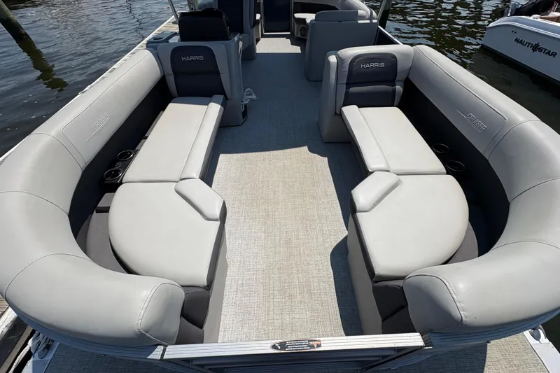 Slide: The Image of 2025 Harris Cruiser 230 pontoon boat with spacious seating and modern design. - 5
