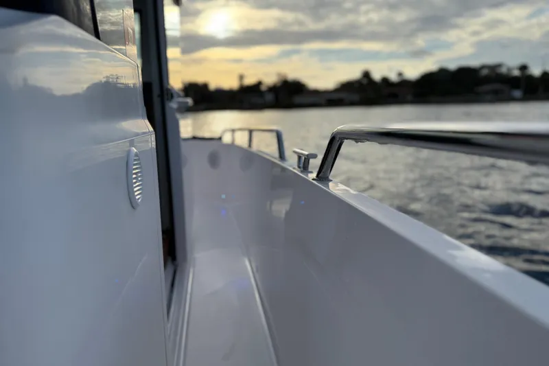 Slide: The Image of 2022 Axopar 28 Cabin boat side view at sunset on the water. - 14