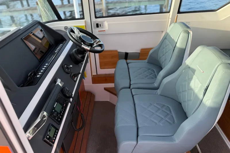 Slide: The Image of Interior of 2022 Axopar 28 Cabin with modern dashboard and comfortable seating. - 17