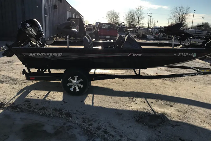 Slide: The Image of 2018 Ranger RT178 boat with Mercury engine on trailer, parked outdoors. - 2