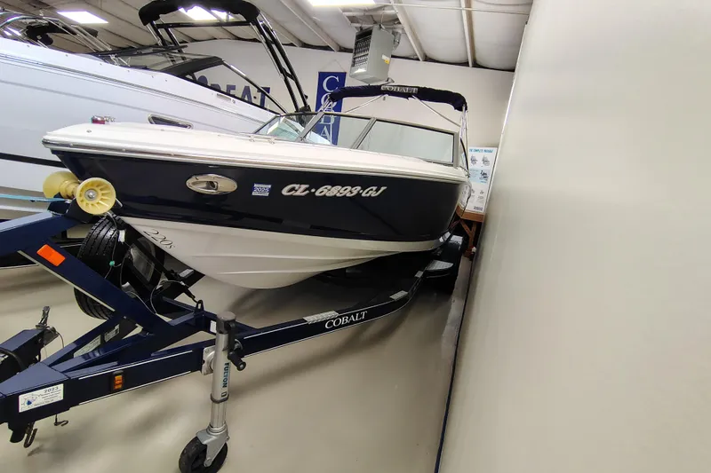 Slide: The Image of 2016 Cobalt 220 boat on trailer in showroom, side view. - 1
