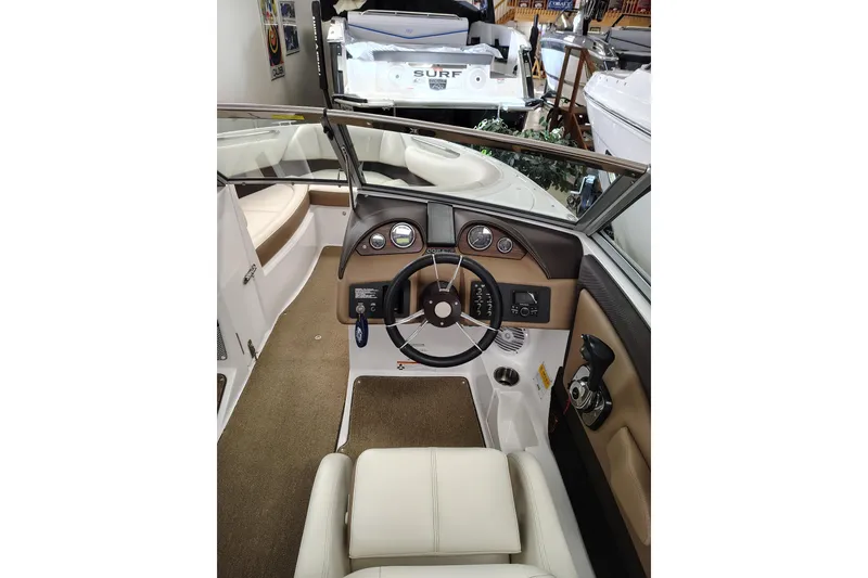 Slide: The Image of Interior view of 2016 Cobalt 220 boat, featuring steering wheel and dashboard controls. - 10