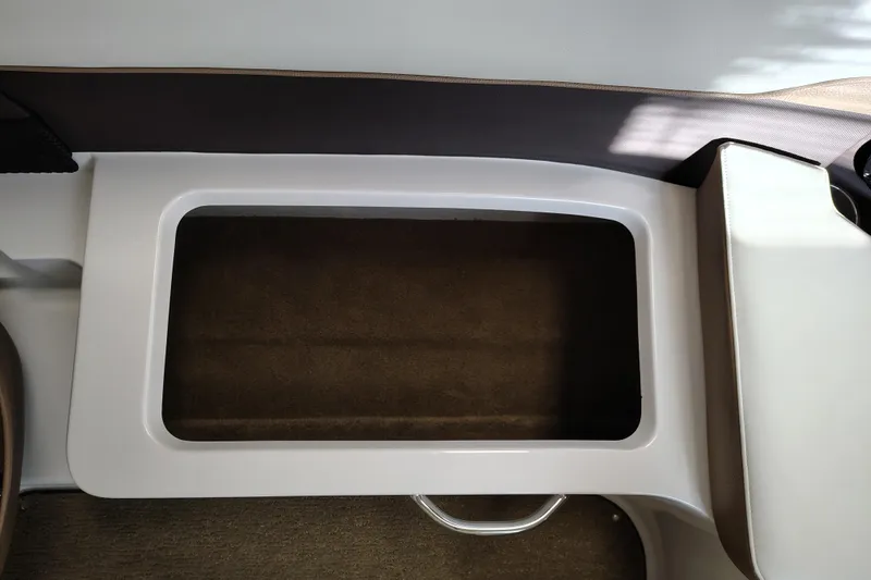 Slide: The Image of Interior storage compartment of a 2016 Cobalt 220 boat, featuring a sleek design. - 18