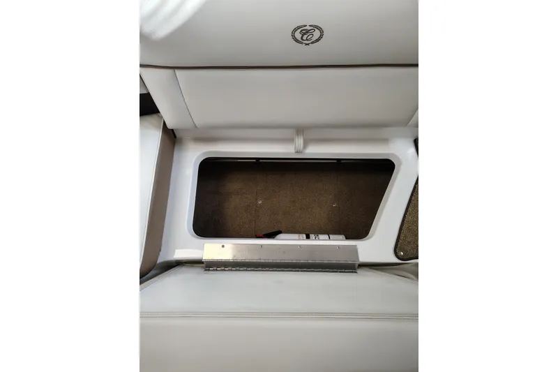 Slide: The Image of 2016 Cobalt 220 boat interior storage compartment with white upholstery. - 19