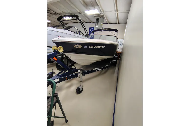 Slide: The Image of 2016 Cobalt 220 boat on trailer in indoor showroom. - 2