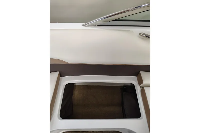 Slide: The Image of 2016 Cobalt 220 boat interior with storage compartment and sleek design. - 20