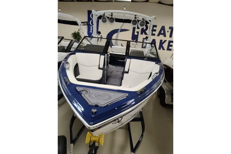Slide: The Image of 2016 Cobalt 220 boat with blue and white interior on display in showroom. - 21