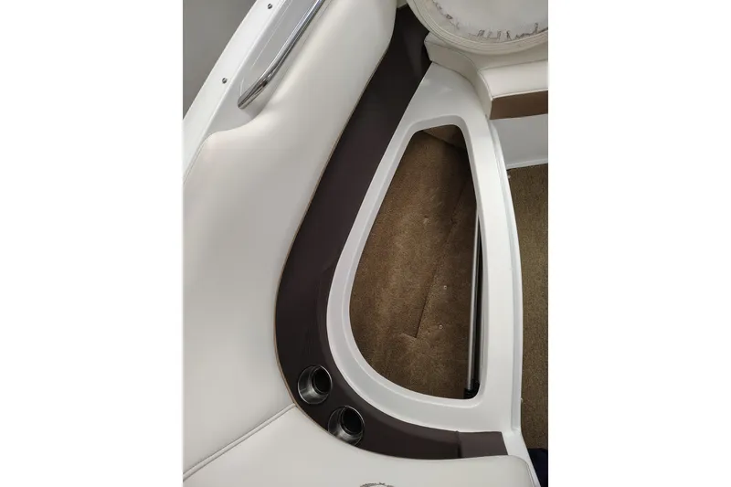 Slide: The Image of Interior view of a 2016 Cobalt 220 boat, featuring white seating and brown accents. - 5