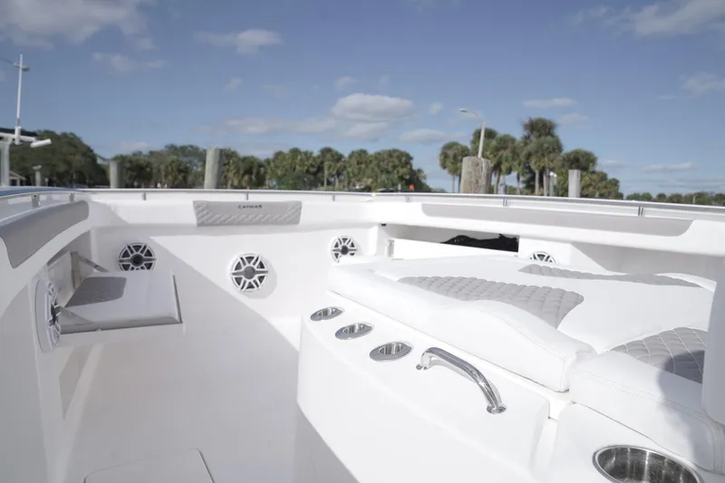 Slide: The Image of 2026 Caymas 34 CT boat on trailer, light blue hull, parked at marina. - 1