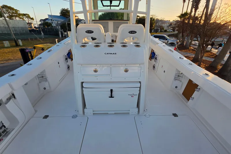 Slide: The Image of 2026 Caymas 34 CT boat deck with seating and storage, under a clear sky. - 10