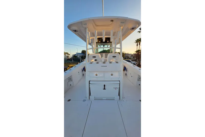 Slide: The Image of 2026 Caymas 34 CT boat interior with helm station and seating, under a clear sky. - 12