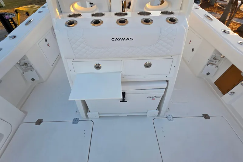 Slide: The Image of Interior of 2026 Caymas 34 CT boat featuring storage compartments and rod holders. - 14